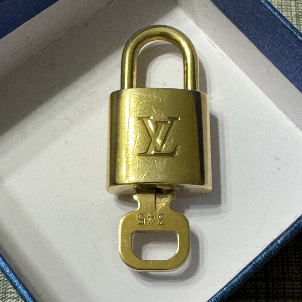 Louis Vuitton; Paris, France; Gold Key W/Lock; #345 (Cayman Islands area code)